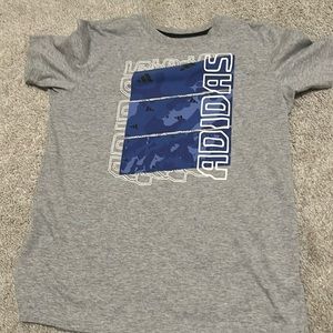 A grey and blue short sleeved adidas t shirt